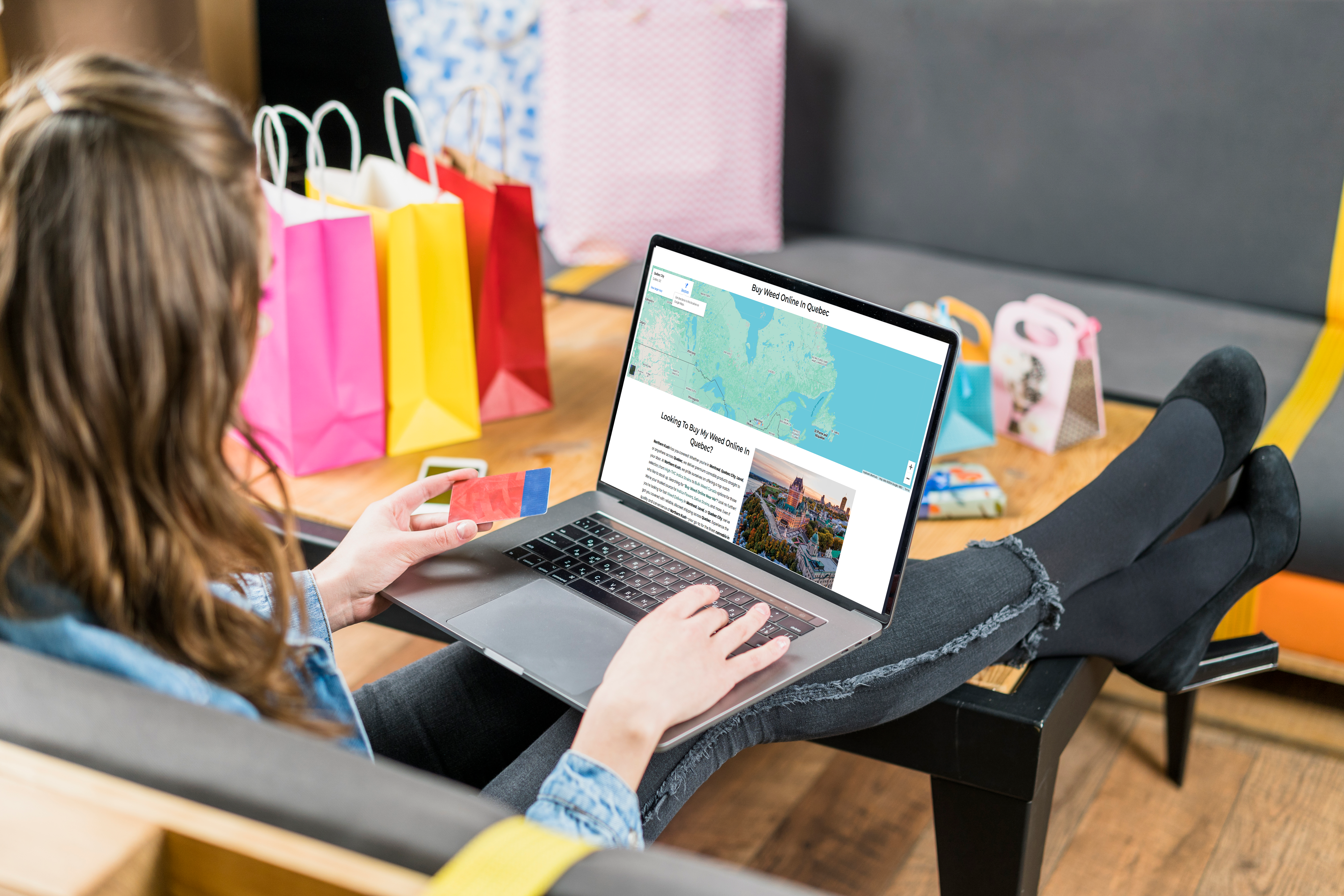 Woman shopping for cannabis online on Northern Kush's website with shopping bags in the background.